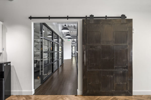Office Hallway with Large Metal Door | Allied Holdings Group in Lehi