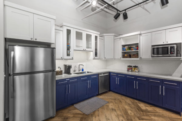Kitchen Area with Blue and White Cabinets in Allied Holdings Group Office | Real Estate in Utah