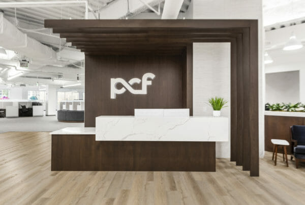 PCF main front desk with large logo | Utah Commercial Real Estate