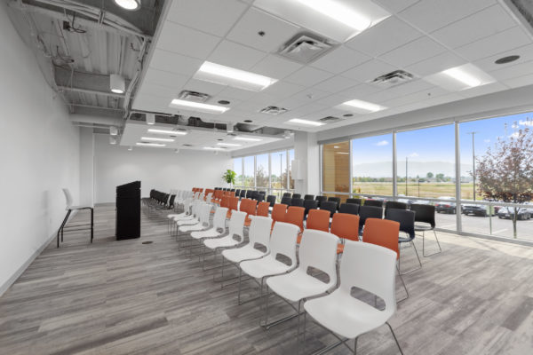 Large meeting room with rows of chairs and a wall of windows with a view | Utah Commercial Real Estate