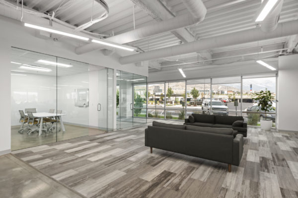 Glass-front office next to open office area with seating | Utah Commercial Real Estate