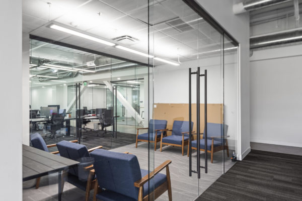 Glass-front office with soft seating inside PCF building exterior | Utah Commercial Real Estate