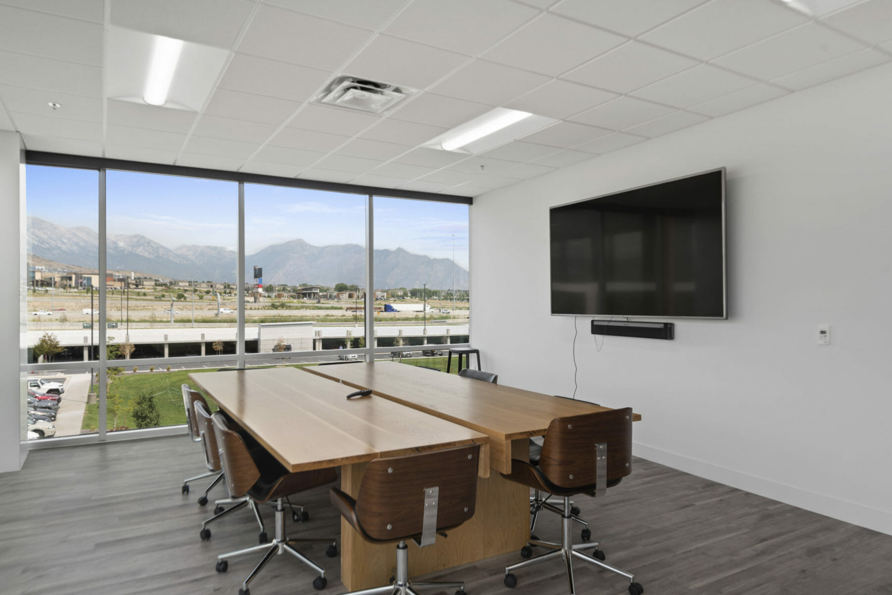 Conference room with wall of windows and mountain view Exterior of Pronto building PCF building exterior | Utah Commercial Real Estate
