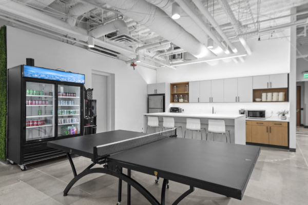 Break are with ping pong table, a large drink fridge, and kitchenette with island | Utah Commercial Real Estate
